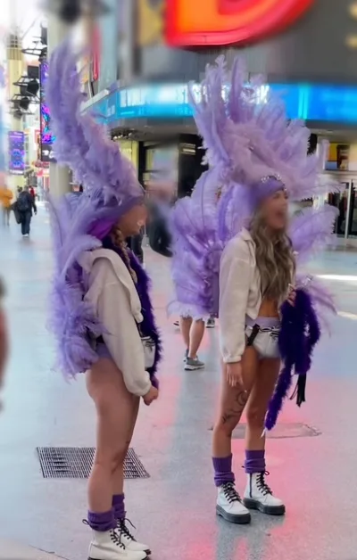 Las Vegas Buskers Dress as Showgirls and pose for tips.