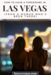 Two topless women from behind, standing on a Las Vegas balcony at night, city lights glowing below.